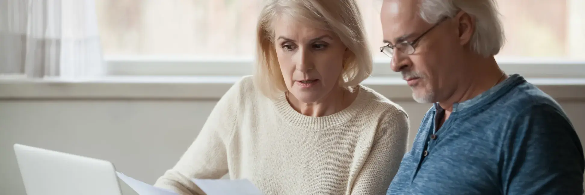 Older couple reviewing estate planning and legal documents in the United States